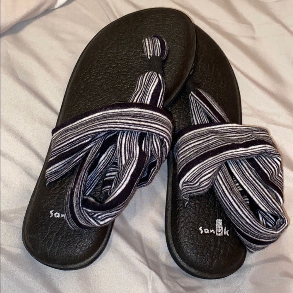 Black and grey Sanuk sandals.